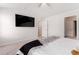 Open bedroom with a mounted TV and access to an ensuite bathroom at 11730 Chatham Dr, Hampton, GA 30228
