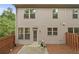 Townhome back exterior featuring a small patio and fenced in yard at 2396 Whiteoak Se Bnd # 16, Smyrna, GA 30080