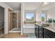 Well-lit bathroom featuring a soaking tub, a glass-enclosed shower, and a dark vanity at 2396 Whiteoak Se Bnd # 16, Smyrna, GA 30080