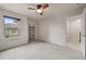 Bright, carpeted bedroom with a ceiling fan, a window, and a built-in shelf at 2396 Whiteoak Se Bnd # 16, Smyrna, GA 30080