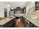 Well-lit kitchen with dark cabinets, stainless steel appliances, and granite countertops at 2396 Whiteoak Se Bnd # 16, Smyrna, GA 30080