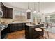 Modern kitchen featuring dark wood cabinetry, stainless steel appliances, and a center island at 2396 Whiteoak Se Bnd # 16, Smyrna, GA 30080