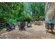 Backyard patio with mature trees, wood fence, and outdoor seating area at 435 Grenock Cir, Atlanta, GA 30328