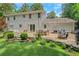 Backyard patio with multiple seating areas, grill, and mature landscaping at 435 Grenock Cir, Atlanta, GA 30328