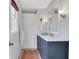 Well-lit bathroom featuring a blue vanity with a marble countertop and a shower with a white curtain at 435 Grenock Cir, Atlanta, GA 30328