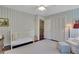 Inviting Bedroom with soft blue striped walls, a white crib, and a comfortable armchair at 435 Grenock Cir, Atlanta, GA 30328