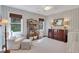 Cozy Bedroom featuring striped walls, a white crib, a comfortable armchair, and a changing table at 435 Grenock Cir, Atlanta, GA 30328