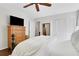Bright bedroom featuring a ceiling fan, a flat-screen TV, wood flooring, and closet with paneled doors at 435 Grenock Cir, Atlanta, GA 30328