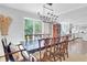 Dining room with large window, chandelier, and view into the kitchen at 435 Grenock Cir, Atlanta, GA 30328