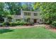 Charming two-story home featuring a well-manicured lawn, mature trees, and classic architectural details at 435 Grenock Cir, Atlanta, GA 30328