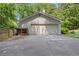 Spacious detached two-car garage with a large driveway and a wood storage area at 435 Grenock Cir, Atlanta, GA 30328