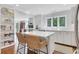 Stylish kitchen with white cabinetry, a center island with seating, and ample natural light at 435 Grenock Cir, Atlanta, GA 30328