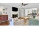 Bright living room with fireplace and open view to dining area at 435 Grenock Cir, Atlanta, GA 30328