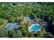 Aerial view of community amenities including tennis courts, pool, and lush landscaping at 5115 Amberden Hall Dr, Suwanee, GA 30024