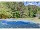 Community basketball court surrounded by trees, perfect for outdoor recreation at 5115 Amberden Hall Dr, Suwanee, GA 30024