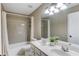 Bright bathroom with a double vanity and a shower and tub combination at 5115 Amberden Hall Dr, Suwanee, GA 30024