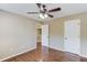 Comfortable bedroom with dark wood ceiling fan and hardwood floors at 5115 Amberden Hall Dr, Suwanee, GA 30024