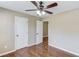 Comfortable bedroom with dark wood ceiling fan and hardwood floors at 5115 Amberden Hall Dr, Suwanee, GA 30024