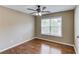 Comfortable bedroom with dark wood ceiling fan and hardwood floors at 5115 Amberden Hall Dr, Suwanee, GA 30024