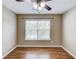 Spare bedroom with wood floors and a large bright window at 5115 Amberden Hall Dr, Suwanee, GA 30024
