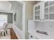 Convenient butler pantry with white cabinets, quartz countertops, and direct access to the dining room at 5115 Amberden Hall Dr, Suwanee, GA 30024