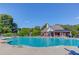 Beautiful community pool with plenty of lounge chairs and a nearby clubhouse at 5115 Amberden Hall Dr, Suwanee, GA 30024