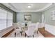 Elegant dining room with hardwood floors, wainscoting, and a modern chandelier at 5115 Amberden Hall Dr, Suwanee, GA 30024