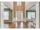 Spacious foyer with hardwood floors and elegant columns leading to the dining area at 5115 Amberden Hall Dr, Suwanee, GA 30024