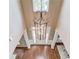 Two story foyer is beautifully lit by an iron chandelier at 5115 Amberden Hall Dr, Suwanee, GA 30024
