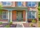 Elegant front door with a covered porch and columns in a classic brick facade at 5115 Amberden Hall Dr, Suwanee, GA 30024