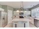 Bright kitchen with stainless steel appliances, white cabinetry, and kitchen island seating at 5115 Amberden Hall Dr, Suwanee, GA 30024