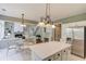 Open concept kitchen with stainless steel appliances and island, connected to the living room and dining area at 5115 Amberden Hall Dr, Suwanee, GA 30024