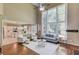 Bright living room with hardwood floors, high ceilings, and a view of the open kitchen at 5115 Amberden Hall Dr, Suwanee, GA 30024