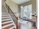 Sun-filled living room boasts hardwood floors, two-story windows, and open staircase at 5115 Amberden Hall Dr, Suwanee, GA 30024