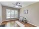 Living room area with hardwood floors, a fireplace, and lots of natural light at 5115 Amberden Hall Dr, Suwanee, GA 30024
