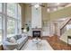 Bright living room with large windows, fireplace, built-ins, and hardwood floors at 5115 Amberden Hall Dr, Suwanee, GA 30024
