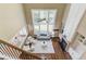 Open living room with hardwood floors, fireplace, and many windows at 5115 Amberden Hall Dr, Suwanee, GA 30024