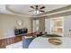 Main bedroom with a tray ceiling has access to a bright en-suite bath at 5115 Amberden Hall Dr, Suwanee, GA 30024