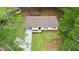 Overhead view of the home showing its landscaped yard, driveway, and proximity to trees at 537 Eastside Dr, Dacula, GA 30019