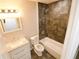 Well-lit bathroom featuring modern tiles in the shower/tub area, new vanity, and fixtures at 537 Eastside Dr, Dacula, GA 30019