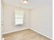 An additional bedroom with hardwood flooring, and a window letting in natural light at 537 Eastside Dr, Dacula, GA 30019
