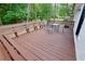 View of the outdoor deck area with built-in bench seating and a metal patio table at 537 Eastside Dr, Dacula, GA 30019