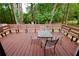 View of spacious deck with wooden bench seating and an outdoor table at 537 Eastside Dr, Dacula, GA 30019