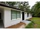 Close up of the home’s exterior highlighting the black trim, fresh paint, and manicured lawn at 537 Eastside Dr, Dacula, GA 30019