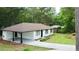 Exterior view of the home featuring a carport, manicured lawn, and freshly painted siding at 537 Eastside Dr, Dacula, GA 30019