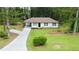 Charming white one-story home with well-maintained lawn and a long, newly paved driveway at 537 Eastside Dr, Dacula, GA 30019