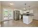 A well-lit kitchen area with stainless appliances, granite countertops, white cabinets, and wood-look flooring at 537 Eastside Dr, Dacula, GA 30019