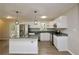 A stylish kitchen featuring granite countertops, stainless steel appliances, white cabinets, and modern pendant lighting at 537 Eastside Dr, Dacula, GA 30019