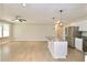 Bright open floor plan featuring a kitchen with granite countertops and stainless steel appliances and light-toned wood floors at 537 Eastside Dr, Dacula, GA 30019