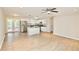 Bright, open-concept living space featuring a modern kitchen with stainless steel appliances and wood floors at 537 Eastside Dr, Dacula, GA 30019